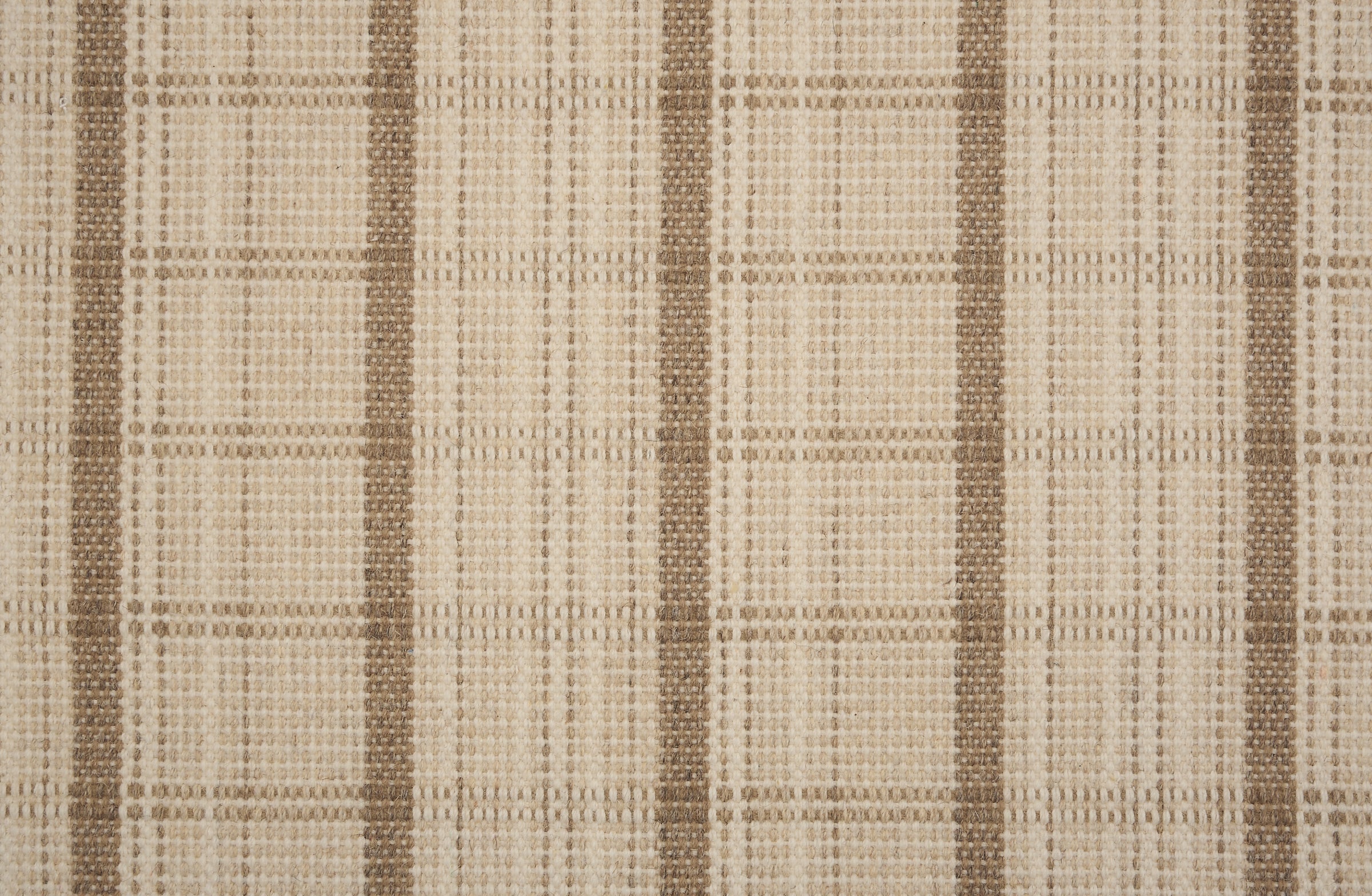 Broadloom carpet in a windowpane plaid in beige and tan.