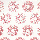 Detail of fabric in a repeating circular geometric print in red on a white field.