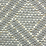 Broadloom carpet in a diamond lattice pattern in light blue and cream. 