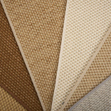 Close-up of broadloom carpet samples in brown, beige, and gray.