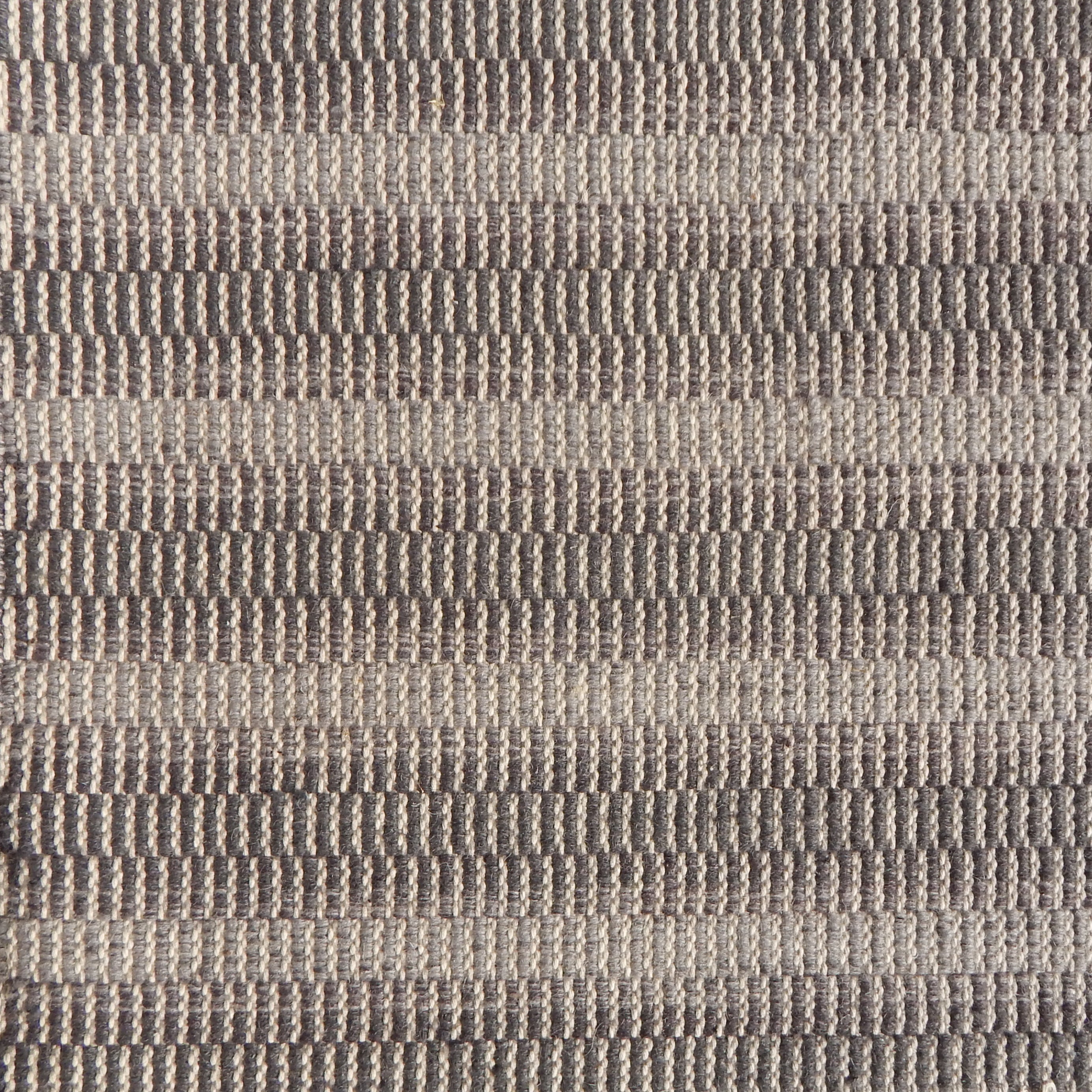 Flatweave rug in a subtle stripe in shades of taupe.