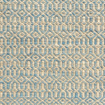 Detail of handwoven rug in an small scale geometric design in beige and blue. 