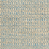 Detail of handwoven rug in an small scale geometric design in beige and blue. 