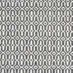 Detail of handwoven rug in an small scale geometric design in white and grey