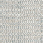 Detail of handwoven rug in an small scale geometric design in white and pale grey-blue