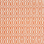 Detail of handwoven rug in an small scale geometric design in white and orange. 