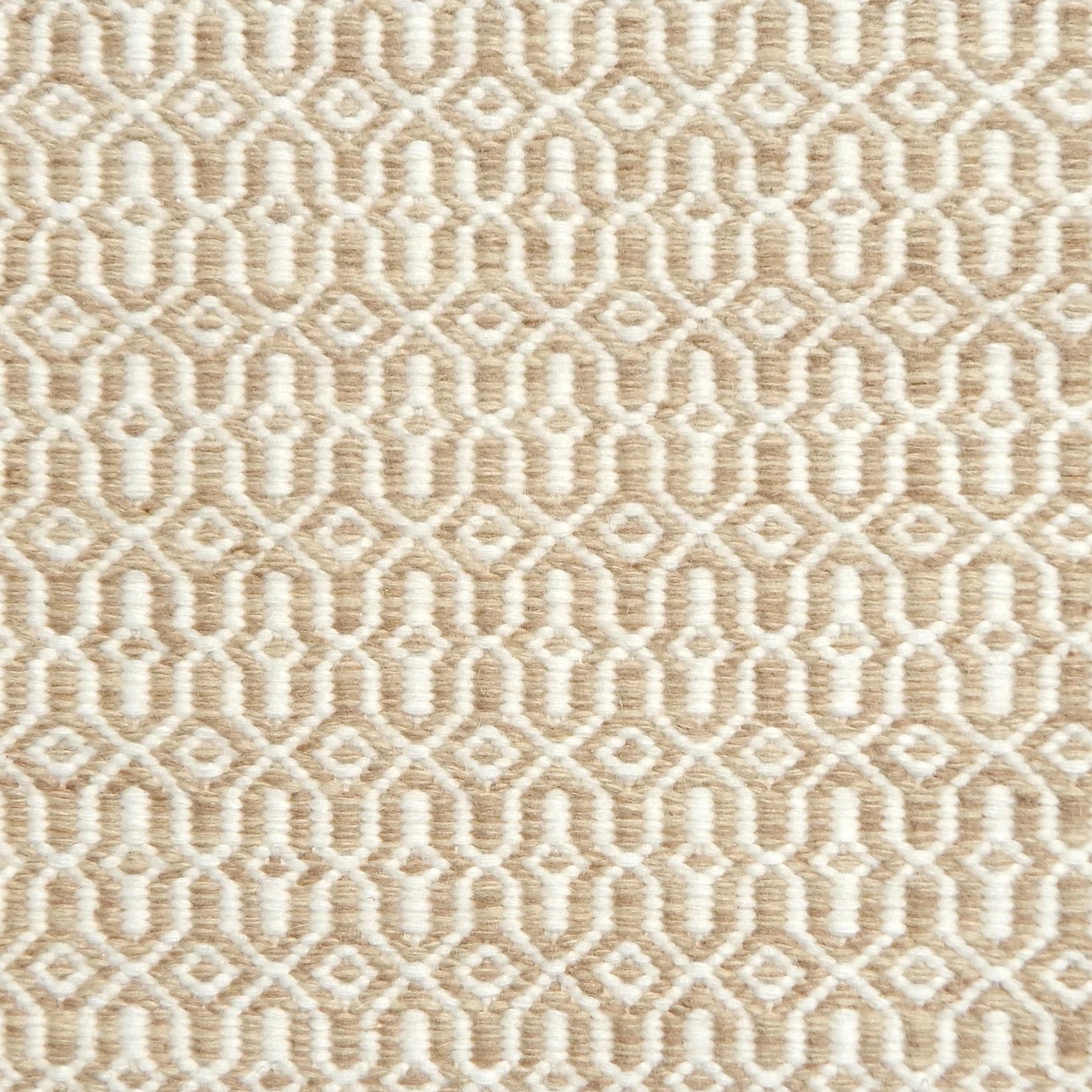 Detail of handwoven rug in an small scale geometric design in beige and white. 