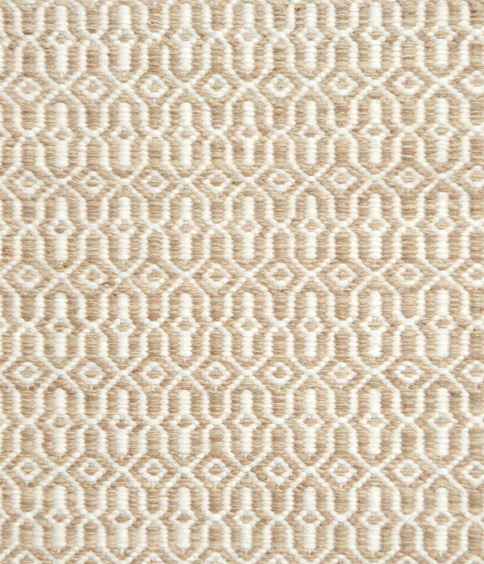 Detail of handwoven rug in an small scale geometric design in beige and white. 
