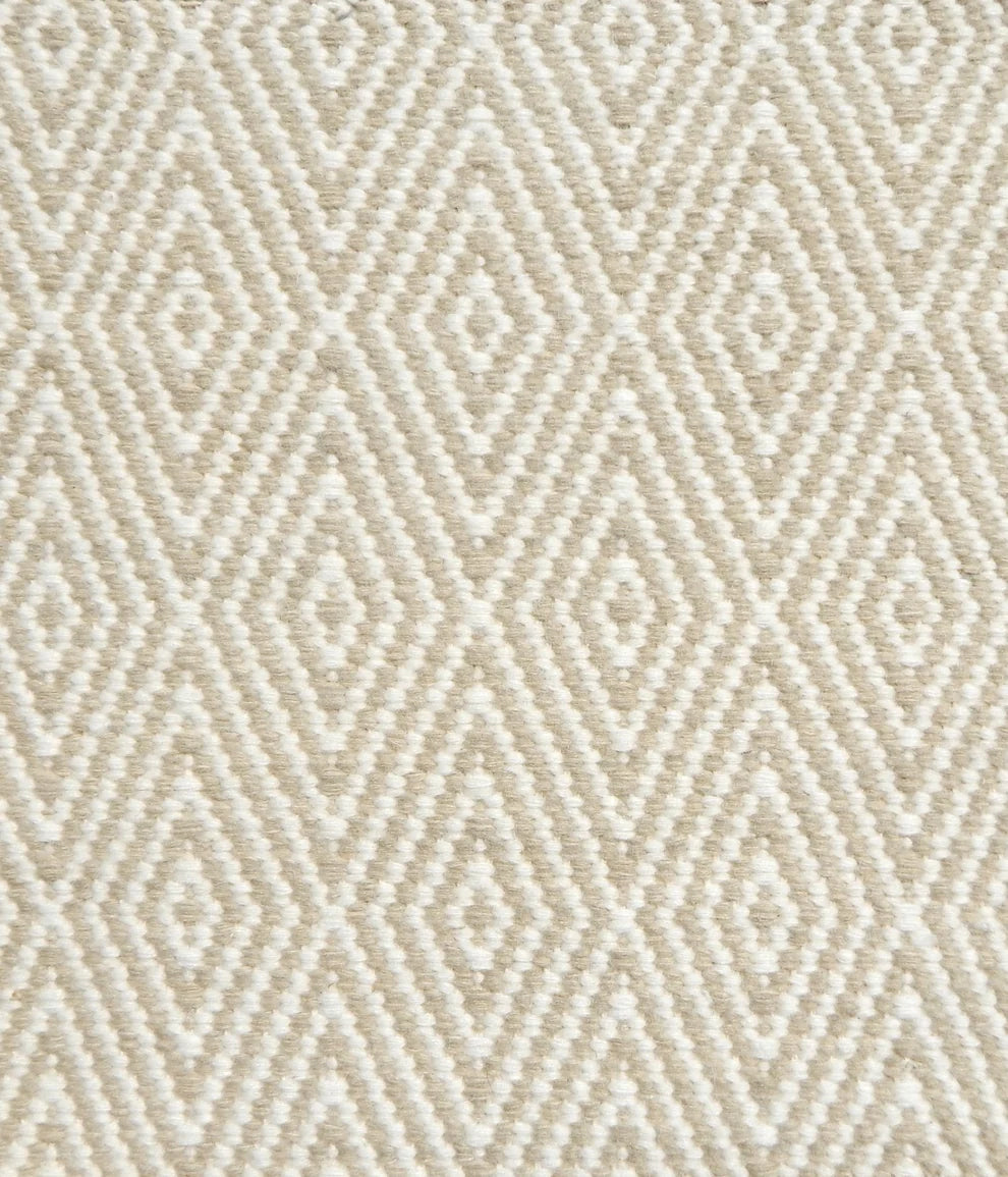 Flatwoven rug detail with a cream and taupe diamond pattern.