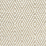 Flatwoven rug detail with a cream and taupe diamond pattern.