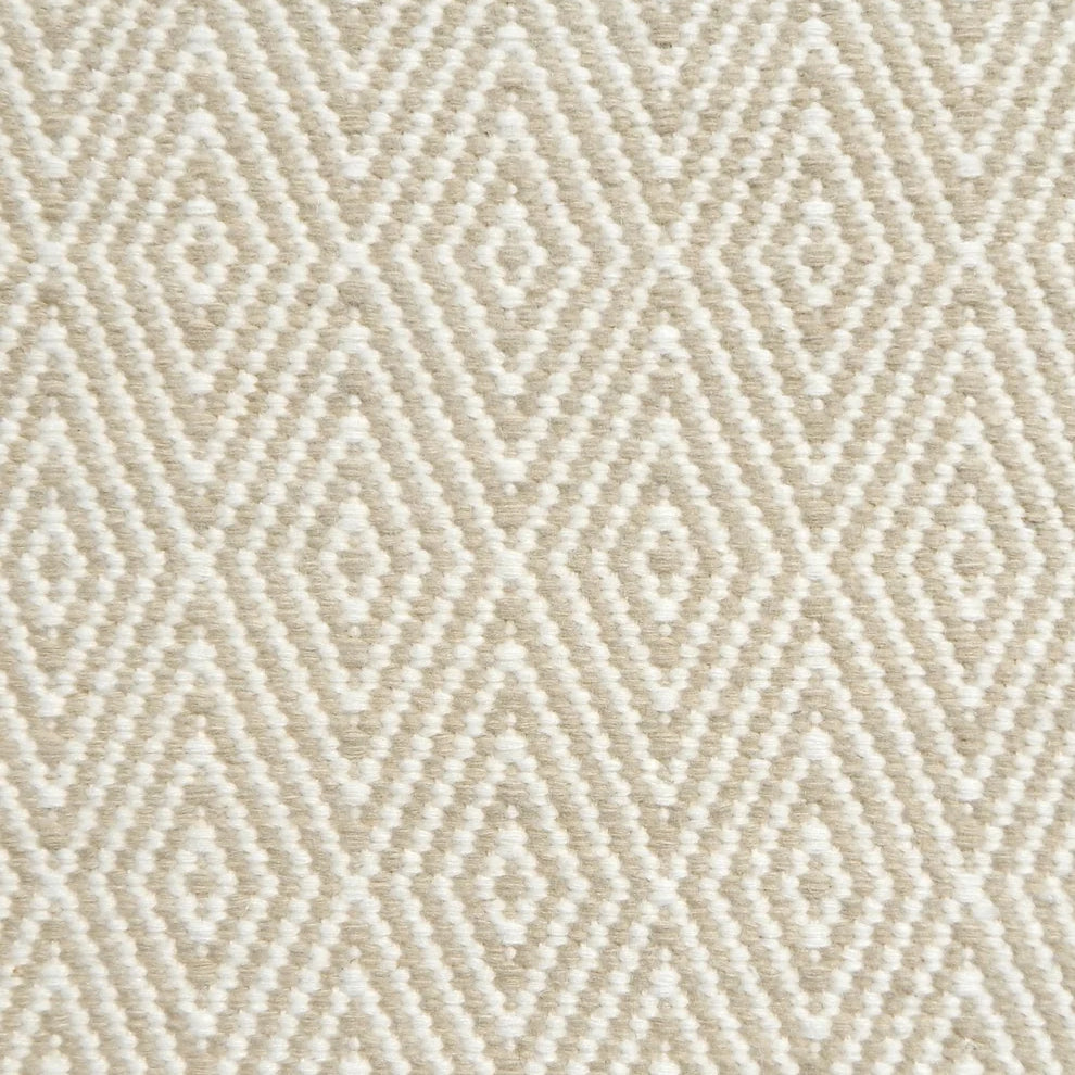 Flatwoven rug detail with a cream and taupe diamond pattern.
