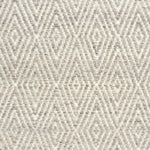 Flatwoven rug detail with a cream and grey diamond pattern.