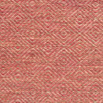 Flatwoven rug detail with a coral red and beige diamond pattern.