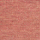 Flatwoven rug detail with a coral red and beige diamond pattern.