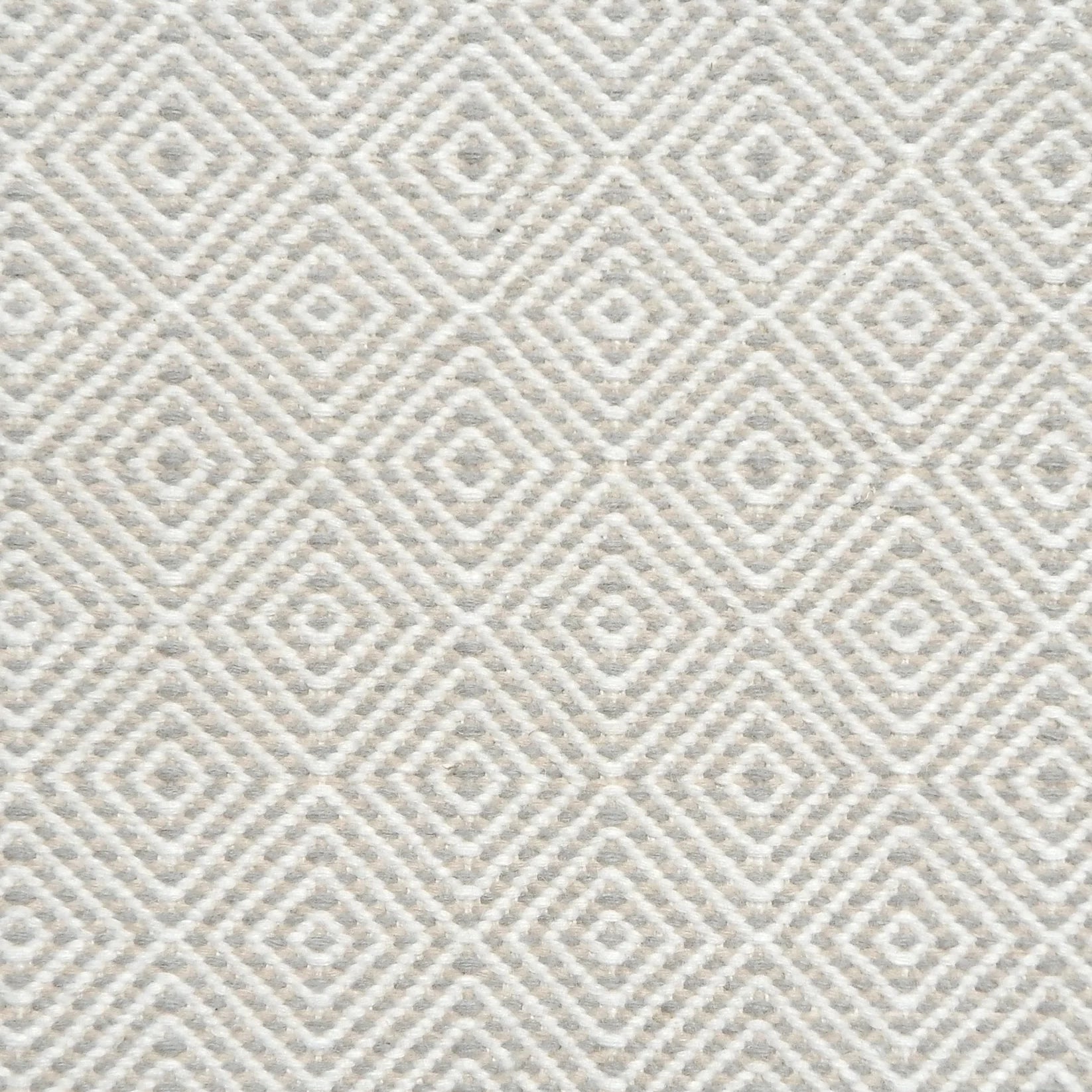 Flatwoven rug detail with a cream and beige diamond pattern.