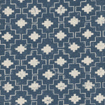 Detail of fabric in a geometric grid print in white on a navy field.