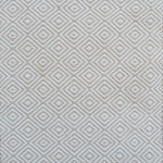 Patterned rug with a geometric diamond design in beige and cream