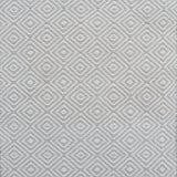 Patterned rug with a geometric diamond design in beige and cream