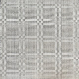 Woven rug in a plaid check in grey and white. 