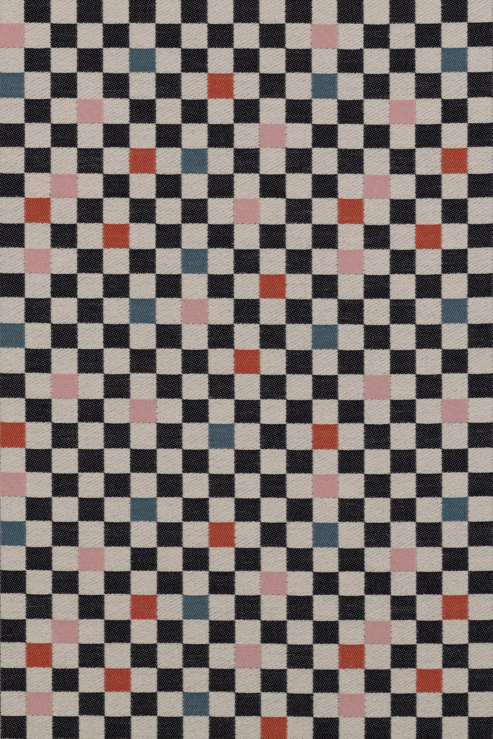 Jacquard fabric in a checked pattern in shades of pink, red, blue and black on a tan field.