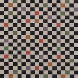 Jacquard fabric in a checked pattern in shades of yellow, pink, purple and black on a tan field.
