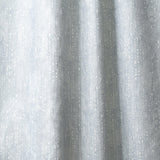 Draped linen in a painterly small-scale dashed dot print in white on a soft grey blue watercolor field.