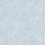 Painterly small-scale dashed dot print in white on a soft blue watercolor field.