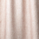 Draped linen in a painterly small-scale dashed dot print in white on a soft pink watercolor field.