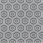 Broadloom carpet in a dimensional hexagonal lattice in white and grey. 