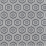 Broadloom carpet in a dimensional hexagonal lattice in white and grey. 