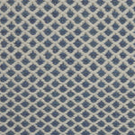 Handwoven rug with small scale diamond lattice in white on a blue field. 