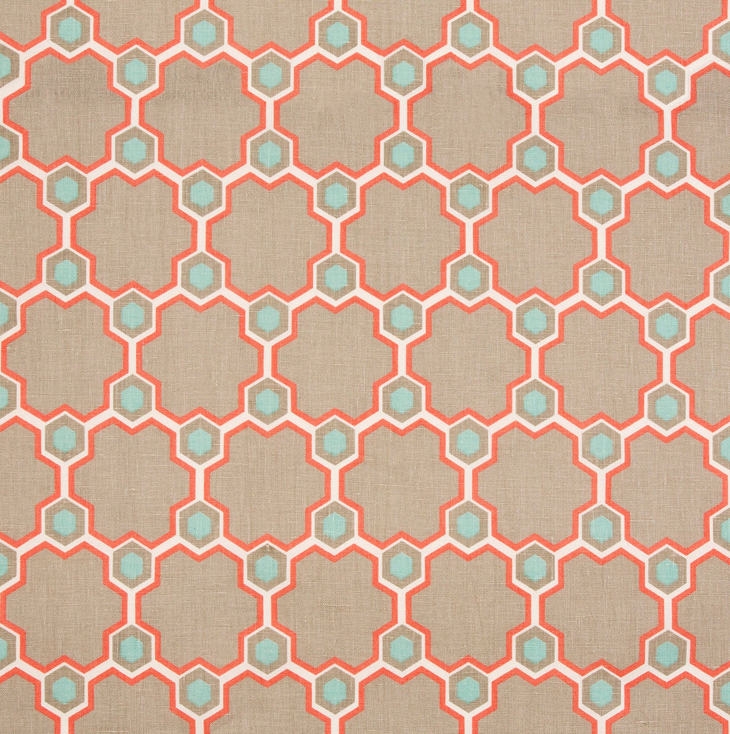 Detail of fabric in a geometric honeycomb pattern in shades of tan, white, blue and coral.
