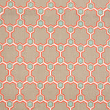 Detail of fabric in a geometric honeycomb pattern in shades of tan, white, blue and coral.