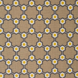 Detail of fabric in a geometric honeycomb pattern in shades of brown, yellow and gray.