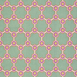 Detail of fabric in a geometric honeycomb pattern in shades of green, purple, white and orange.