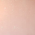 Detail of a wallpaper in a random splattered pattern in metallic cream on a pink field.