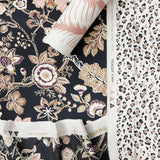 Styled flat-lay featuring a dark floral vine pattern in fabric and wallpaper paired with a roll of tropical print wallpaper in blush and white layered over a black and blush pink leopard print wallpaper. 