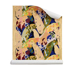 Roll of wallpaper with painterly collaged palm frond pattern in gold, olive green, blue, pint and purple on a white background