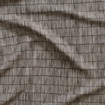 Close up of gently draped woven Indoor-Outdoor fabric with thin hand drawn stripe grid in white on black. 