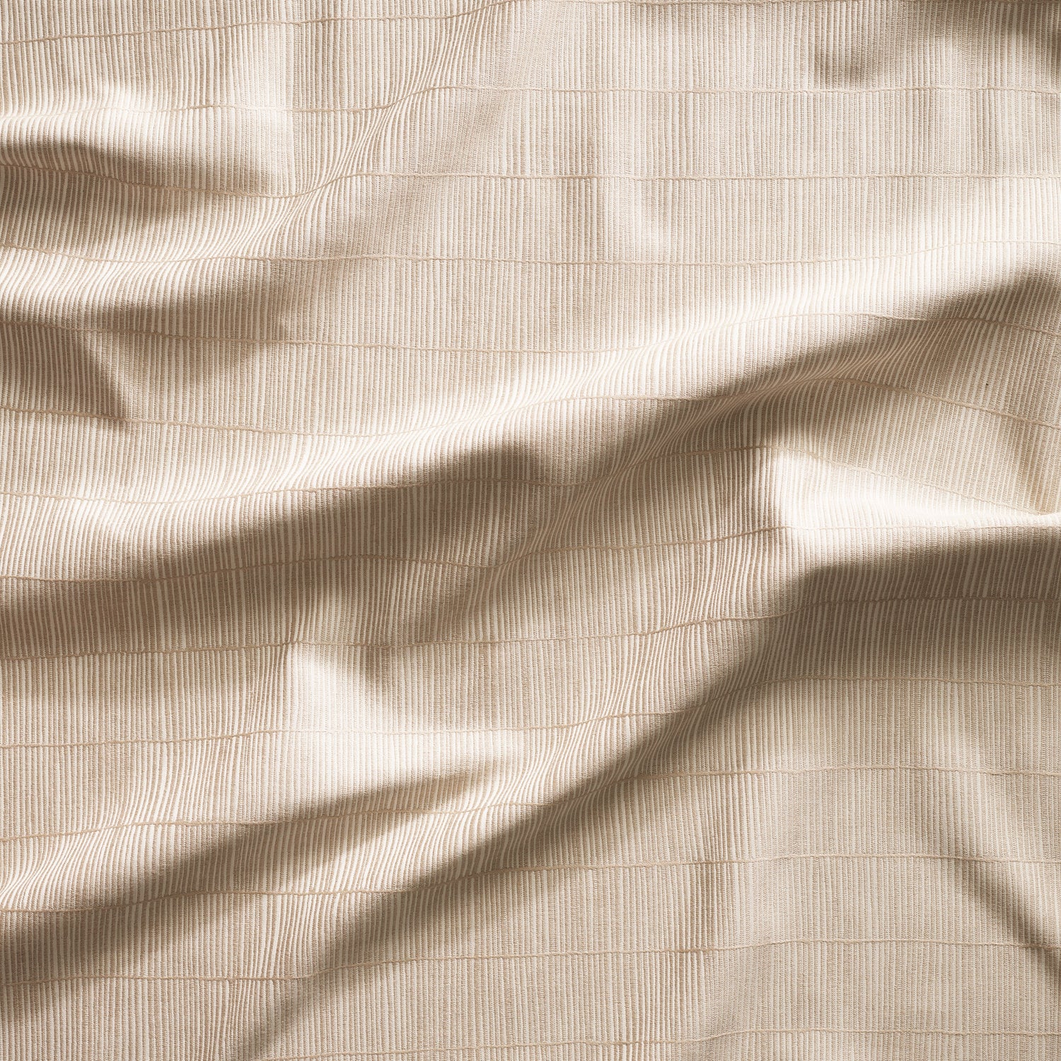 Close up of gently draped woven Indoor-Outdoor fabric with thin hand drawn stripe grid in ivory on ecru.