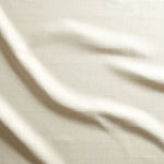 Close up of gently draped woven Indoor-Outdoor fabric with thin hand drawn stripe grid in ivory.