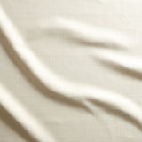 Close up of gently draped woven Indoor-Outdoor fabric with thin hand drawn stripe grid in ivory.