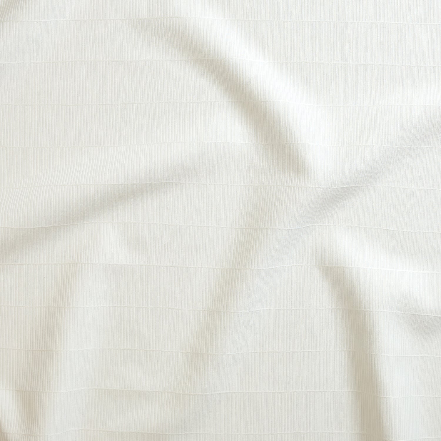 Close up of gently draped woven Indoor-Outdoor fabric with thin hand drawn stripe grid in white.