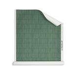 Roll of wallpaper with dashed striped grid in tonal green.