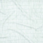 Close up of gently draped printed linen with thin hand drawn stripe grid in ivory on light blue.