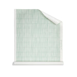 Roll of wallpaper with dashed striped grid in white in sea foam blue.