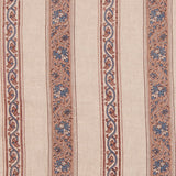 Detail of fabric in a striped paisley print in blue and brown on a cream field.