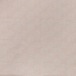 Printed linen fabric in a repeating camellia pattern in white on a light pink field.