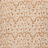 Detail of fabric in an abstract tribal print in orange on a tan field.