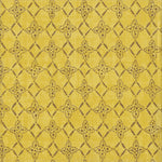 Detail of fabric in a botanical lattice print in brown on a mottled yellow field.